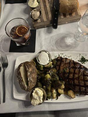 The ribeye meal, paired with a smoked in front of old fashioned