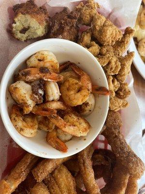 Grilled shrimp, gator bites, hush puppies and onion rings.