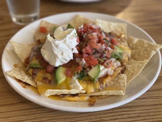 Huevos Ernesto Spicy shredded beef is added to the Huevos Rancheros, topped with pico de gallo and sour cream.