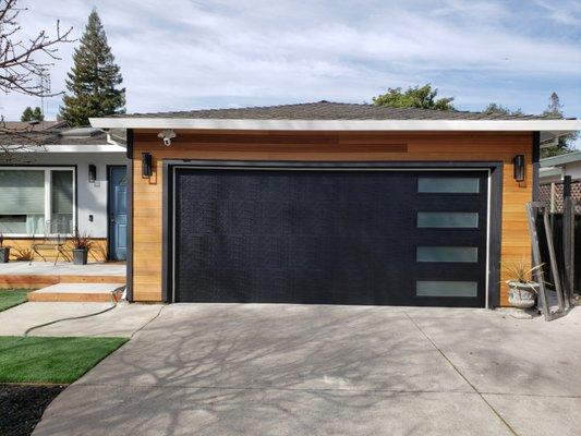 Modern garage door with vertical stacked satin etched glass.