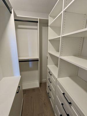 White walk-in closet with matte black hardware in Rancho Santa Margarita.