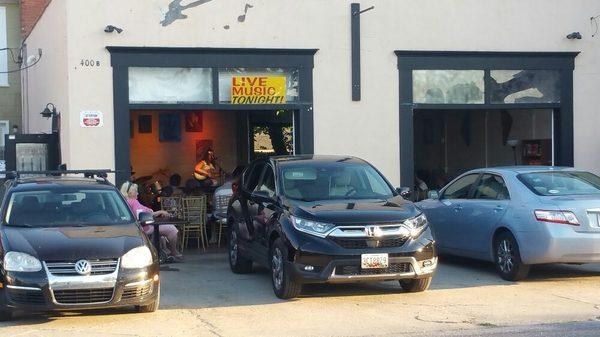 Open Mic Night on a cool summer evening with the garage doors open