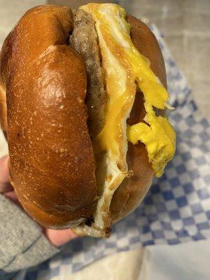 Breakfast sandwich- sausage, egg and cheddar on a plain bagel