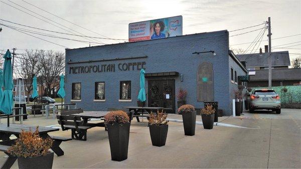 The coffeehouse's exterior with a drive through and outdoor seating for when it's the right thing to do (2021)