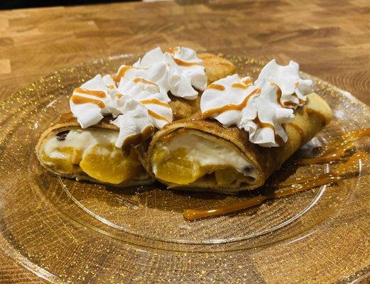 "Peaches N Cream" Blintz. Wrapped with cannoli cream and peaches. Topped with dulce de leche, whipped cream, and Oreo pieces.