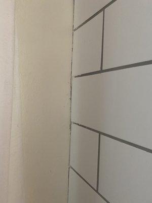 Completely uneven grout all the way down the wall