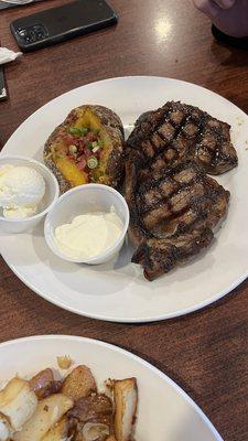 Ribeye and Loaded Potato - perfectly cooked and well seasoned! 10/10