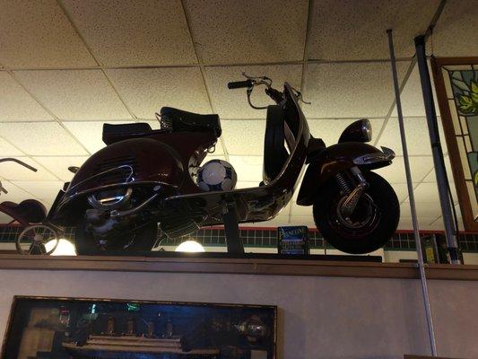 Yes, an antique motorcycle is part of the decor