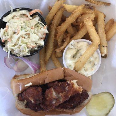 this is a clam roll with fries and a takeout container