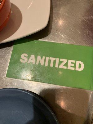 "Sanitized" signs on each clean table!