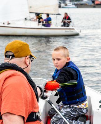 Child on Spectator Boat picked up one of the Nerf missiles to send back into battle for his parent!