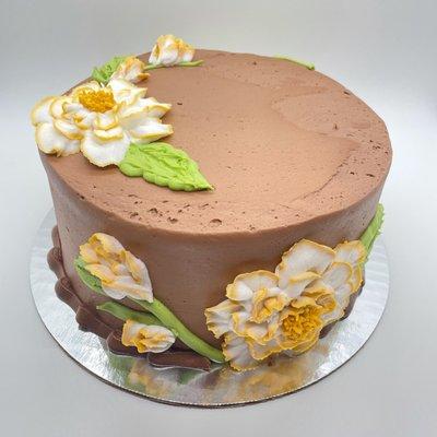 Floral decor on chocolate cake with chocolate buttercream icing.