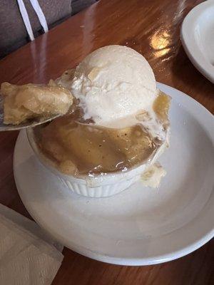 Peach cobbler with ice cream.