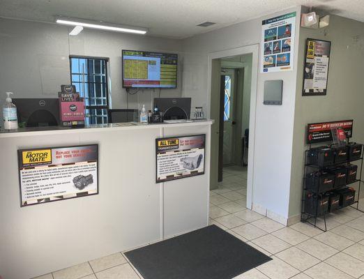 The front desk that you'll see a soon as you walk in with our digital display showing out popular services as well as hand sanitizers.