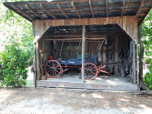 Wagon outside next to chicken coup.