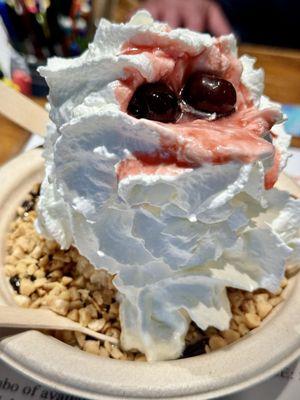 sundae with salted caramel ice cream, topped with hot fudge, toffee, whip cream and cherries