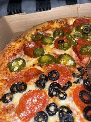 Pepperoni with half black olives and jalapeños