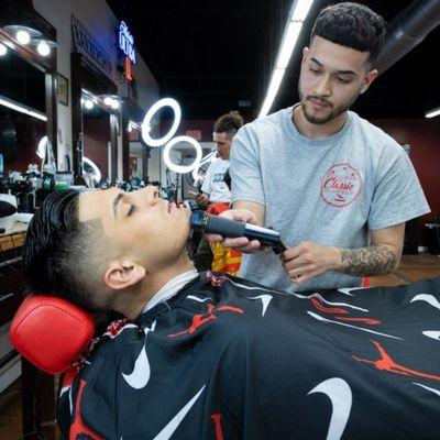 Our barber Juan finishes shaving a client