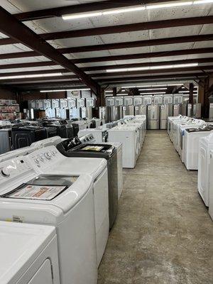 So many top load washers! More refrigerators in background!