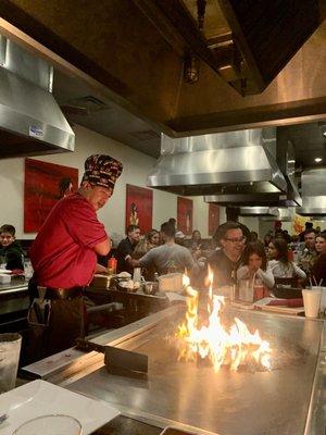 Teppanyaki table inside the restaurant where you sit, watch, eat.