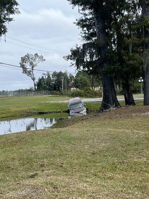 Car left behind in the same pond as the bar.