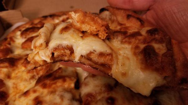 Small (13", six slice) Buffalo Chicken Finger Pizza [medium, blue cheese base sauce] - Great shot of the chicken fingers under the mozz!