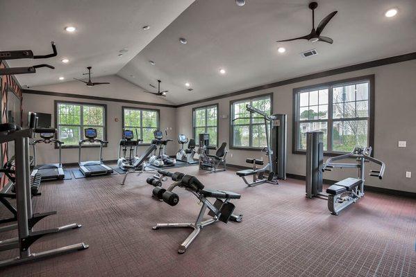 the gym has plenty of exercise equipment and windows at Sterling Creek