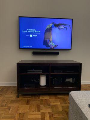 Mounted TV and Soundbar.