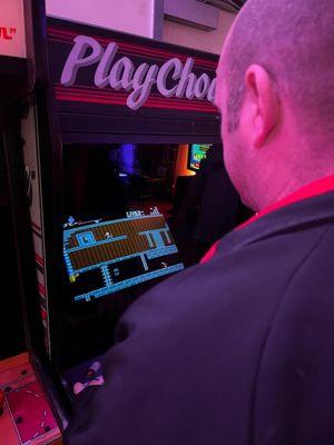 Playing a machine with a variety of games offered on it.