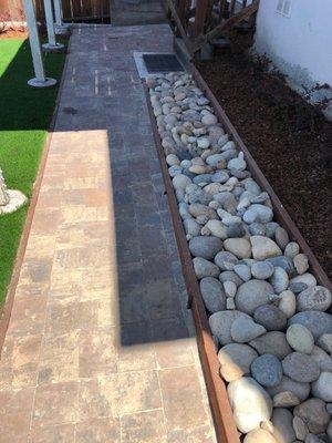 Stone walkway, bed of stones and soon to be full grown bushes (on the right) planted.