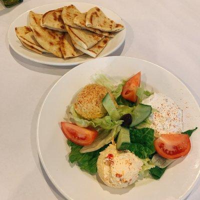 Three spread platter : hummus, tzatziki, and spicy feta