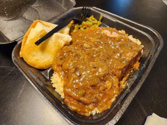 Smothered pork chop with rice, green beans and garlic. I'm going to need an extra stomach.