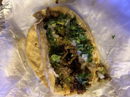 Steak taco with cilantro onion and corn tortilla