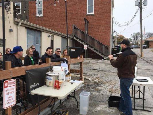 Brian F leading a beginner brewing class on the patio.