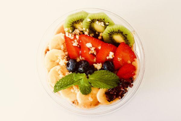 Lilikoi (passionfruit) Bowl with Lots of fresh fruits and granola on the top.