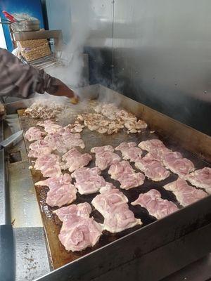 Cooking chicken for chicken teriyaki.