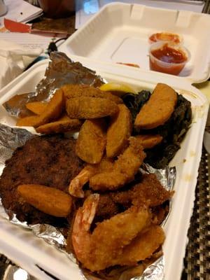 Fried seafood platter with wedges and collard greens