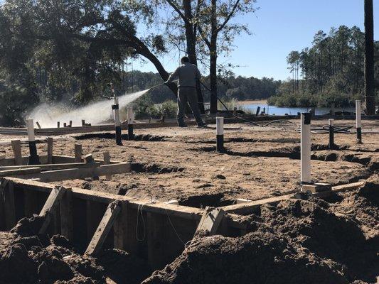 Our termite pretreatment technician, Joel Nelson, completing a service for a new home foundation.