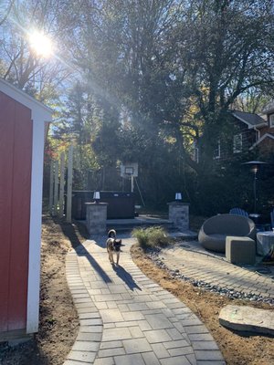 Mighty Pavers walkway leading to elevated patio and outdoor shower.