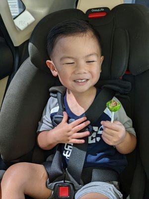 He's super happy with his haircut and lollipop