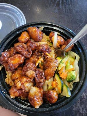 Spicy orange chicken bowl with fried rice and stir fry veggies