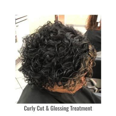 Lots of layering cut into curls to add fullness and definition to the hairstyle. Black ammonia-free hair color used to add depth and shine.