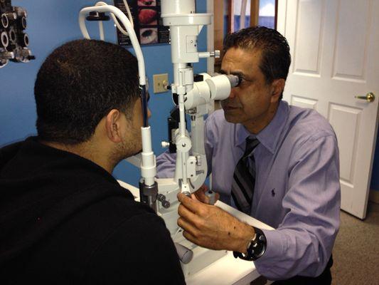 Westoaks office: Dr. Khalfe examining the anterior segment of the eye.