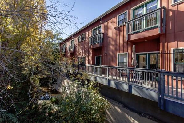 Nestled in the historic Soda Water Works building overlooking the Creek.