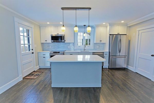 Kitchen Renovation in Melrose. White Shaker Kitchen, Grey Island with quartz countertops.