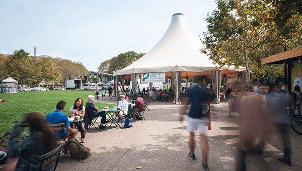 A tented area, chairs, and café tables