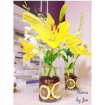 Yellow lilies and lemon accents bring sunshine to any home, party, or event.