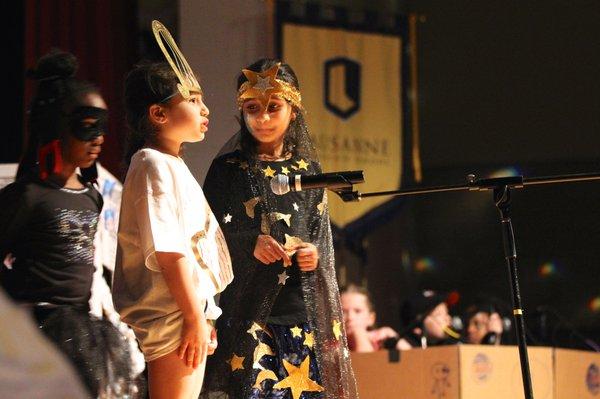 Lower School students present their findings about the solar system during convocation.