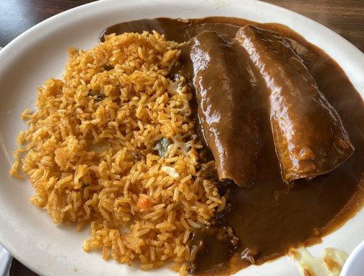 Enchilada Poblanos with mole sauce & cheese, served with rice.