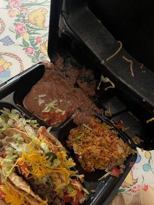 The spilt food and lettuce on tacos.